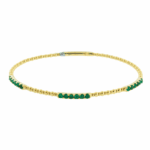 beaded design bangle with green emeralds in yellow gold
