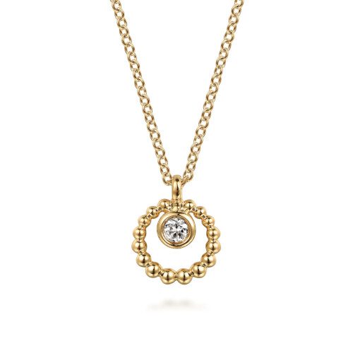 Bujukan style circle with small white sapphire in middle on chain all in yellow gold