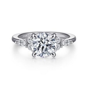 white gold diamond engagement ring with two rounds and a marquise on either side of center stone