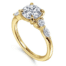 diamond engagement ring with one round and one marquise diamond on each side of center stone in yellow gold
