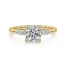 all yellow gold engagement ring with a marquise shaped diamond on either side of center stone
