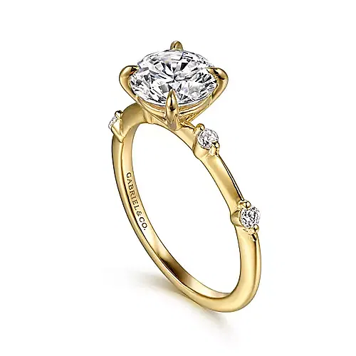 yellow gold engagement ring with 4 side diamonds, two on each side of center stone, shared prong set, round center