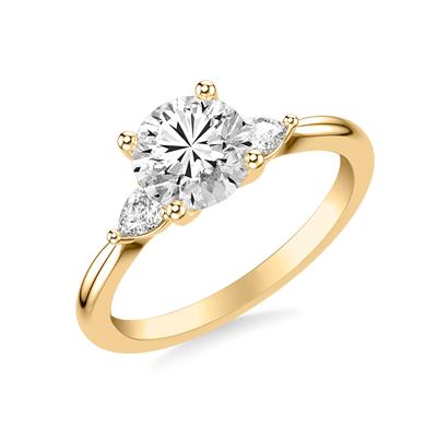 3 stone diamond engagement ring in yellow gold, one pear shaped diamond on either side of center stone