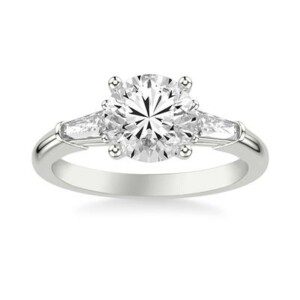 3 stone white gold diamond engagement ring with 1 tapered baguette diamond on either side of center stone