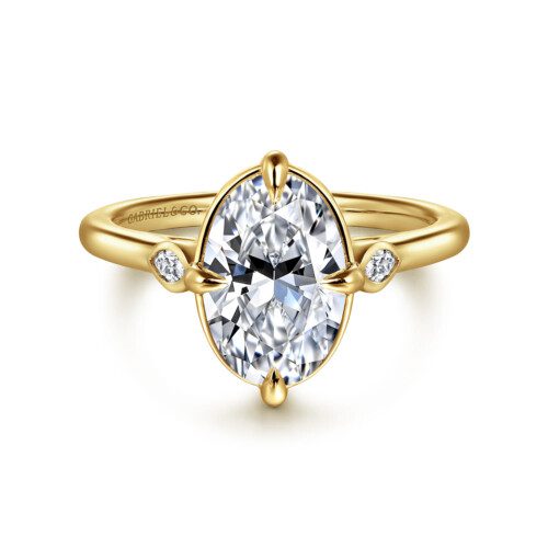 three stone engagement ring in yellow gold 4 prongs on north east south and west sides of center stone