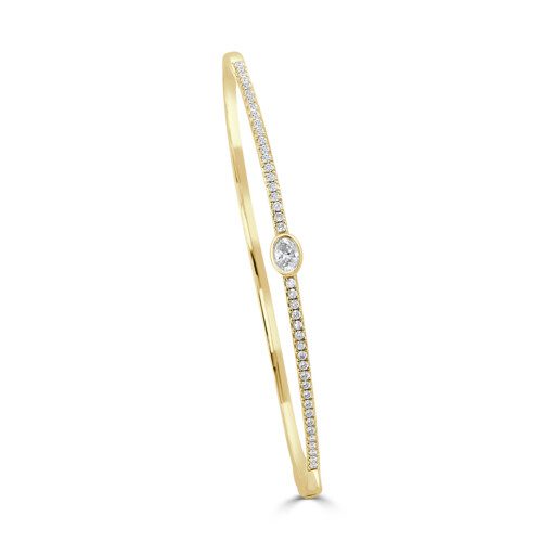 yellow gold bangle bracelet with diamonds on front and oval shape bezel set diamond in center